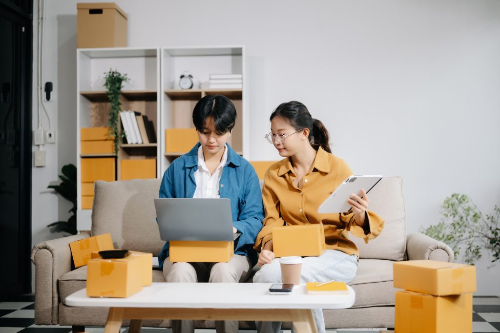 Asian young attractive couple man and woman use tablet and smartphone online shopping furniture